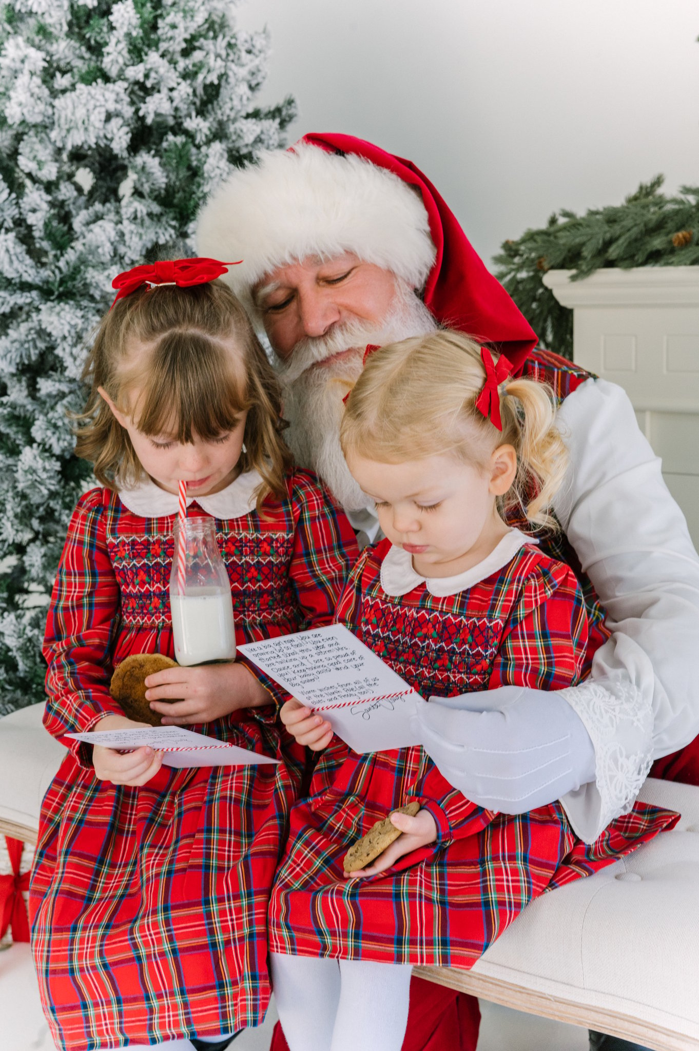 Christmas in Dallas with Santa and two young girls reading a letter from Santa and eating milk and cookies.