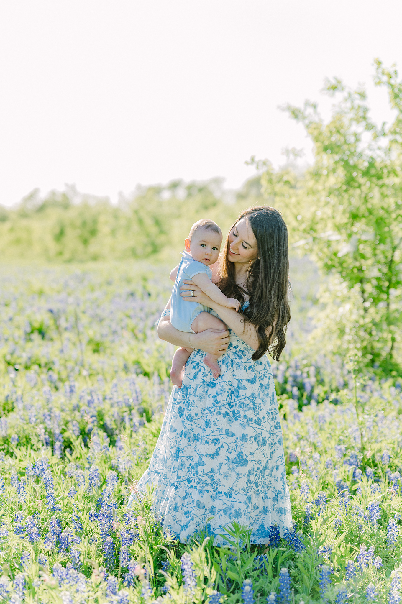 Mother adoring her baby in a field of bluebonnets in Dallas